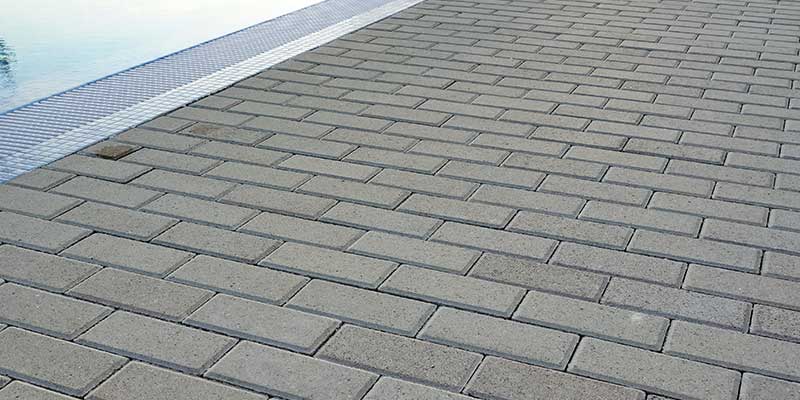 We Lay Slip Resistant Heat Reflective Pavers That Frame Your Pool